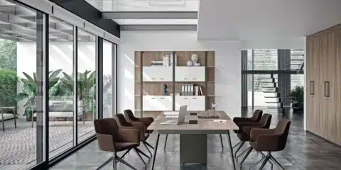 Collaborative X3 desks in a bright room with screens and divider panels.