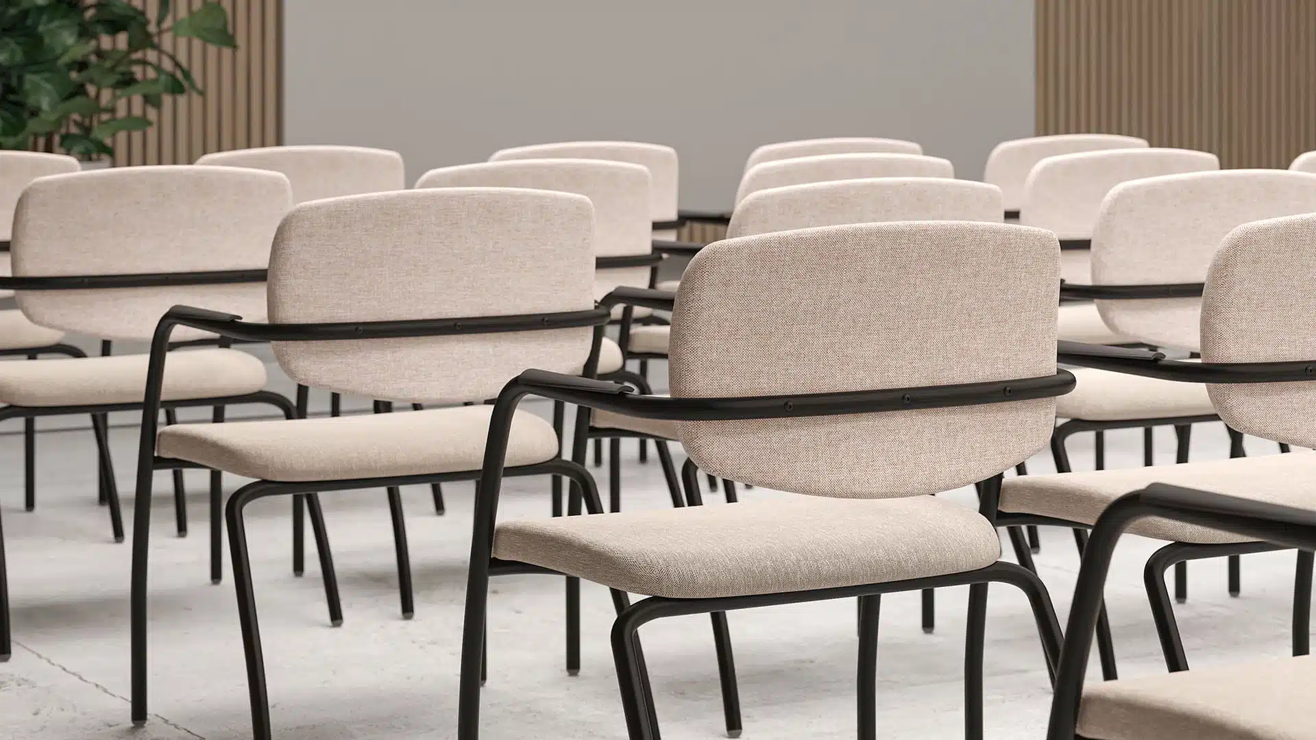 GAMA multi-purpose stackable office chair with black 4-leg frame and beige fabric upholstery in a conference room setting.