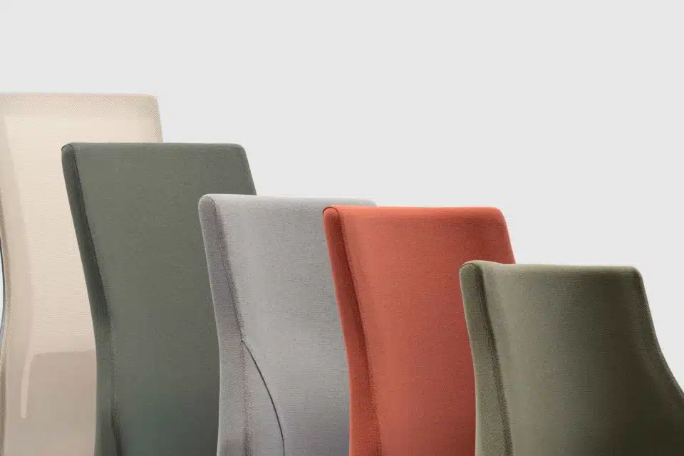 Close-up of RH Axia chair backrests in various heights and colours, shown in beige mesh and upholstered fabric.