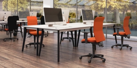 Air Ergonomic Chair in orange in a large open-plan room.