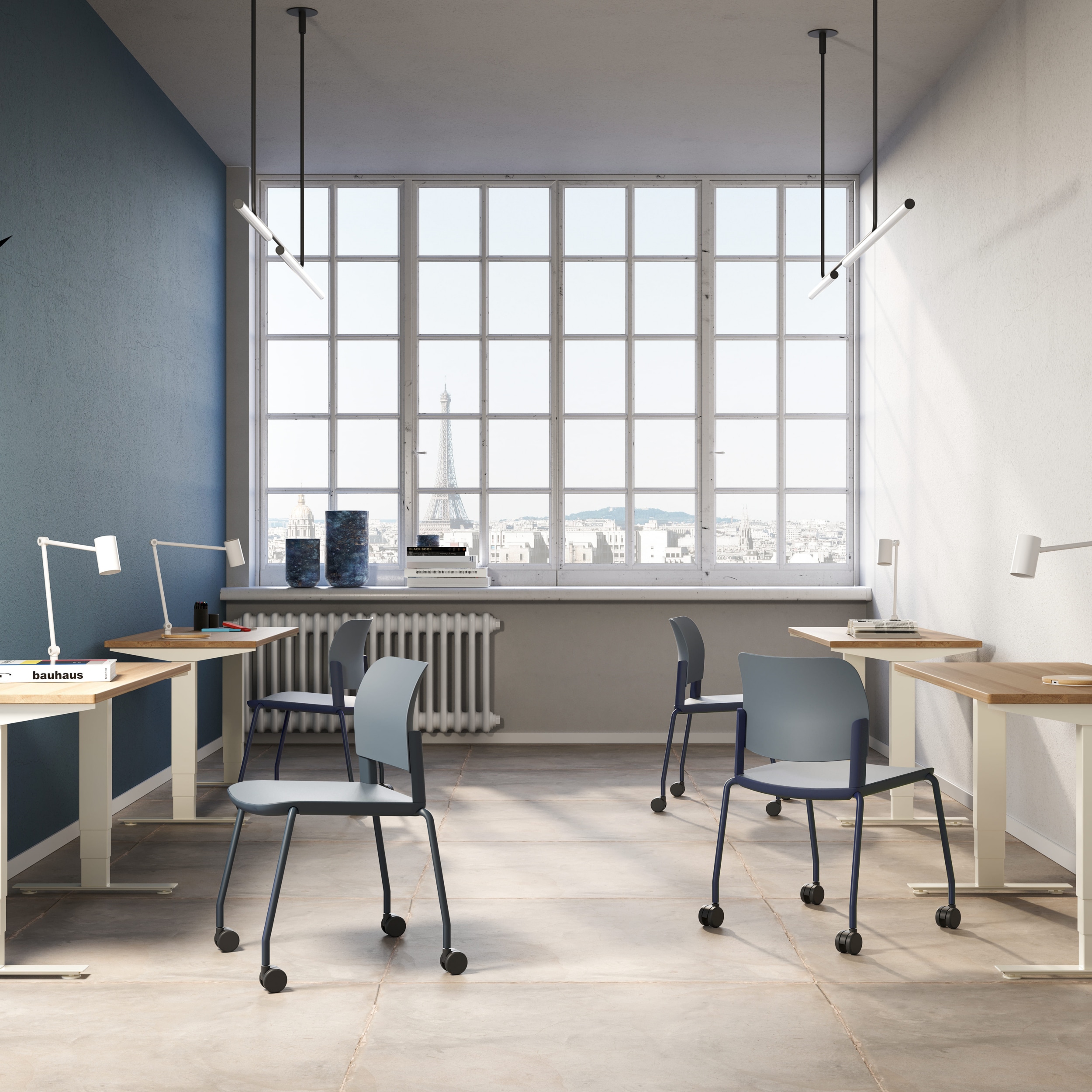 Commercial office design featuring individual sit-stand desks and mobile blue task chairs in a modern iQ Workspace setting with a view of the Eiffel Tower.