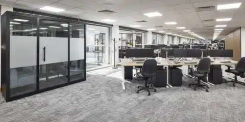 Modern open-plan office at MSC Ipswich featuring a black acoustic meeting pod, Imperial sit-stand desks and ergonomic chairs.