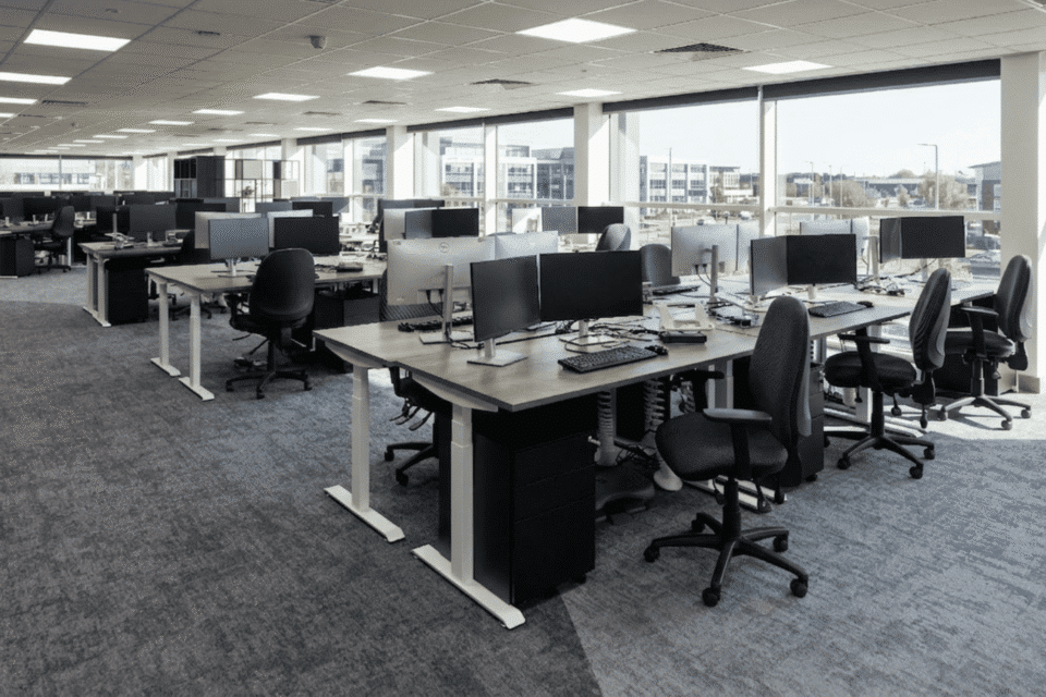 close-up photograph focusing on an individual workstation within the brightly lit MSC Ipswich open-plan office.