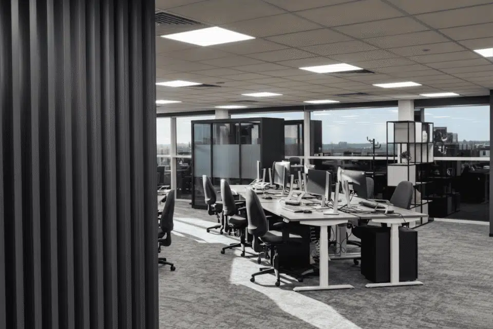 Refurbished open-plan office at MSC Ipswich featuring a prominent black slatted partition wall, Imperial sit-stand desks, and ergonomic seating.