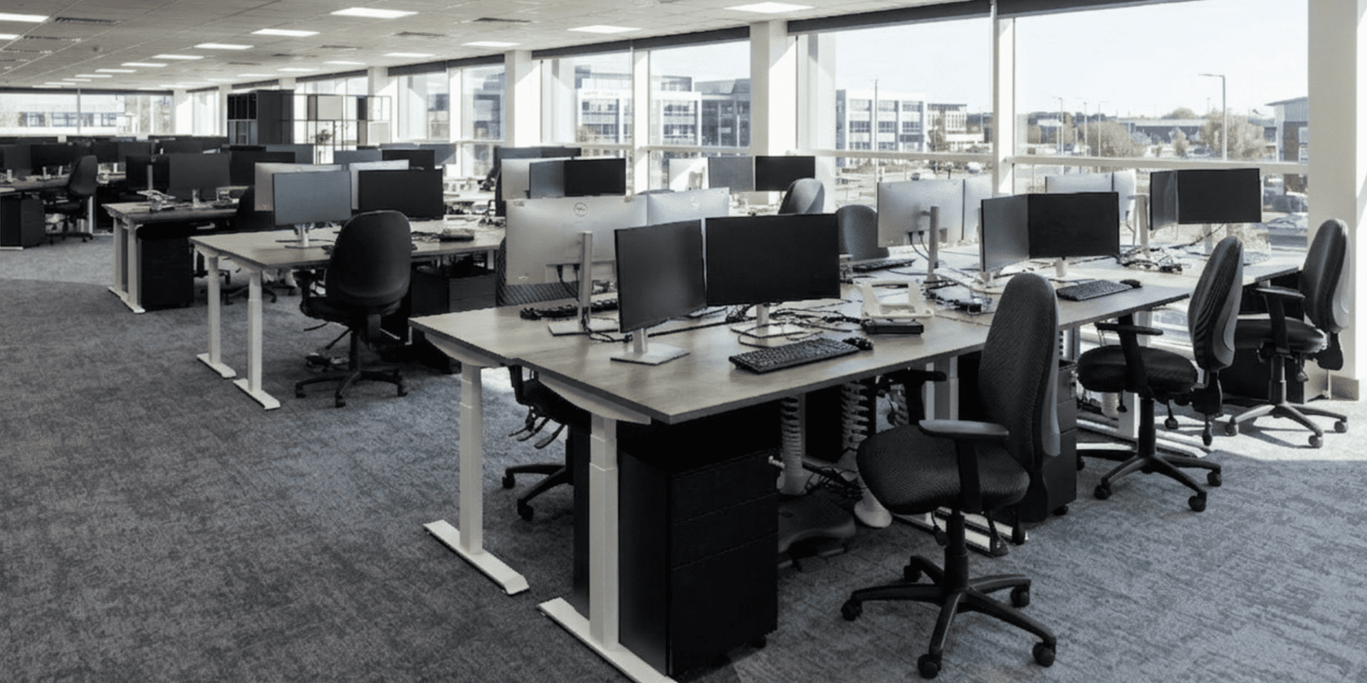 Close-up of an Imperial electric sit-stand desk and a Tick ergonomic office chair.