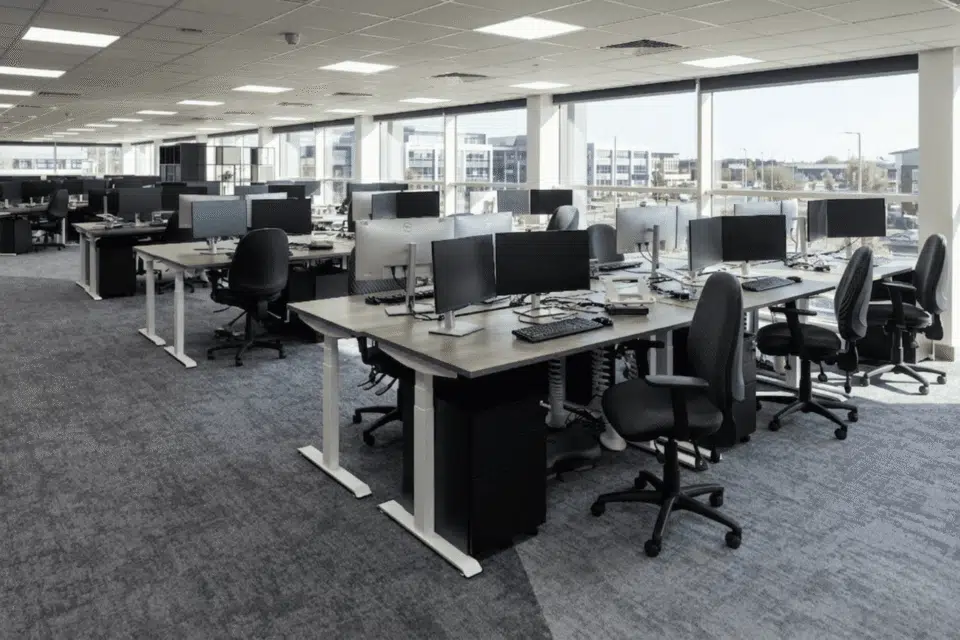 Close-up of an Imperial electric sit-stand desk and a Tick ergonomic office chair.