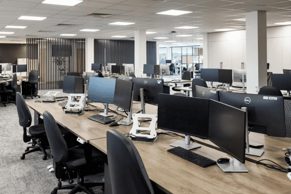 Close-up of an Imperial electric sit-stand desk and a Tick ergonomic office.
